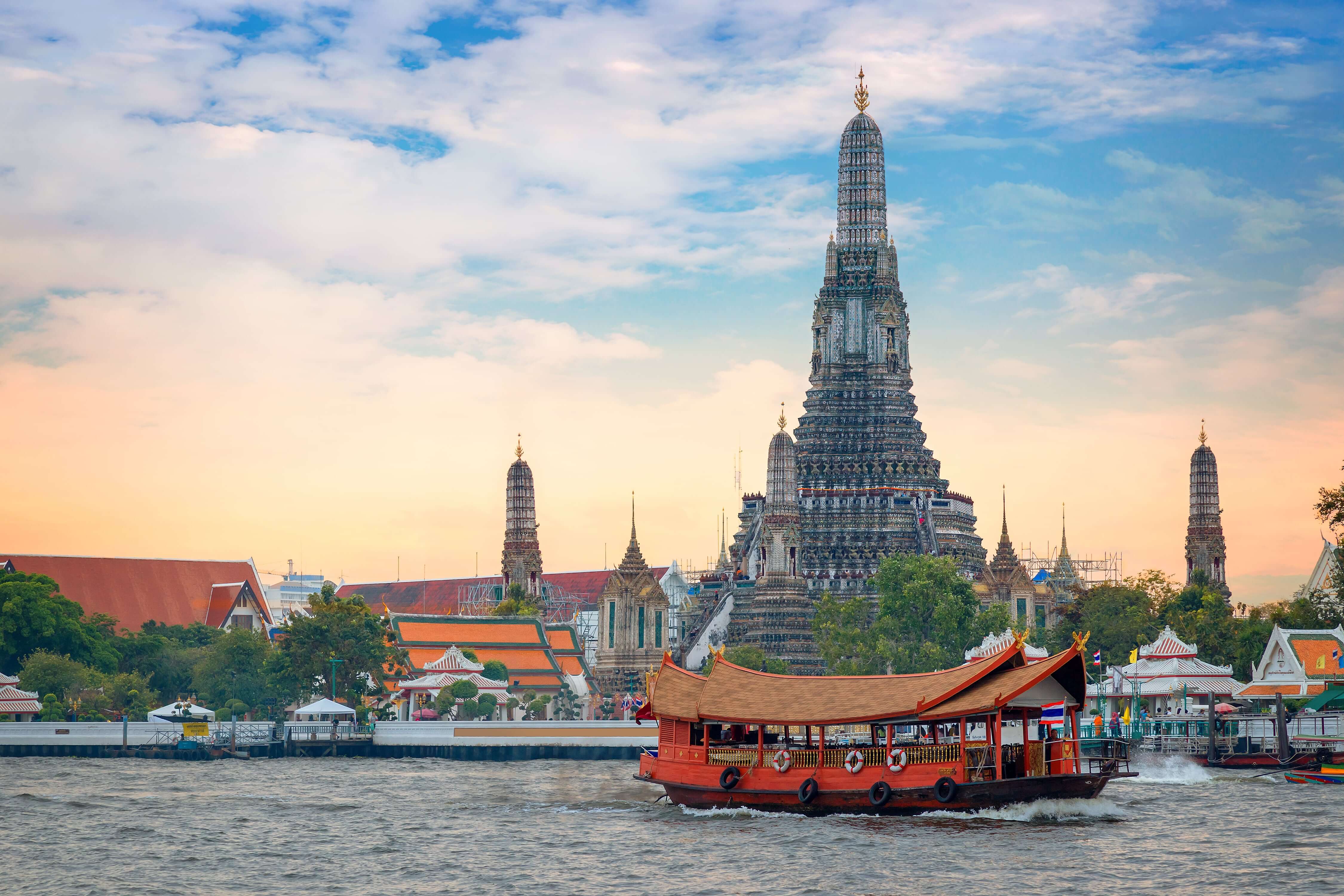 Wat Arun - the Temple of Dawn with a boat frontview in Bangkok, Thailand